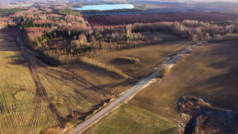 Aerial-approaching-view-of-peat-extraction-bog-on-a-sunny-spring-day