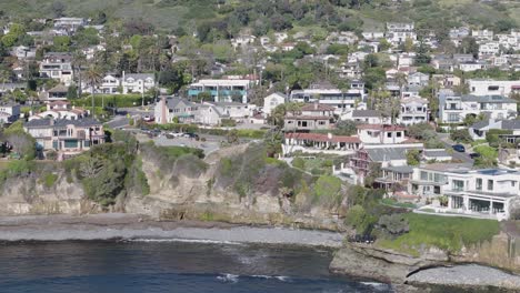 Aerial-track-back-of-neighborhood-in-the-hills-of-San-Diego,-California-on-a-bright-sunny-day