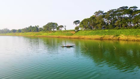 Fisherman-Fishing-at-Boat-In-Surma-River,-Bangladesh---Aerial-Drone-Shot