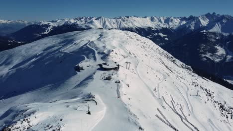 Ski-resort-on-mountain-ridge-with-lift-and-station,-aerial