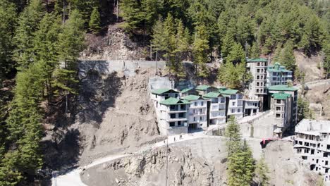 Residential-buildings-on-a-steep-slope-surrounded-by-pine-trees