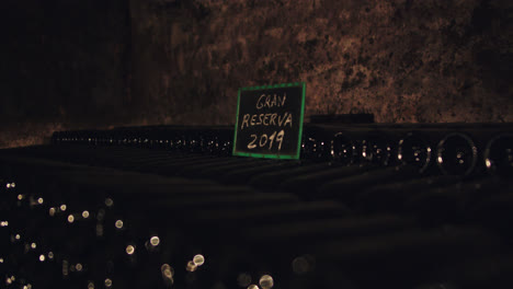 Beautiful-slow-motion-shot-of-a-2019-wine-reserve-inside-a-subway-cellar-in-a-cave-in-Burgos,-Spain