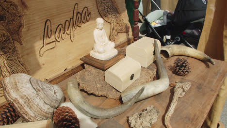 Beautiful-slow-motion-shot-of-medieval-and-Buddhist-objects-at-a-stall-inside-the-medieval-fair-of-Huelva-in-Spain-during-a-summer-morning