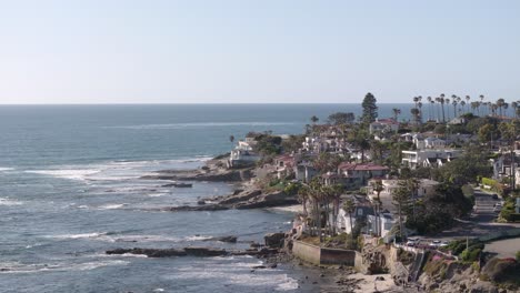 Aerial-track-back-of-oceanside-homes-on-a-cliff-in-San-Diego,-California-on-a-sunny-day