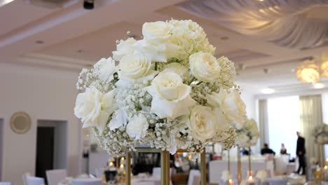 Wedding-reception-decoration,-white-roses-in-a-tall-vase