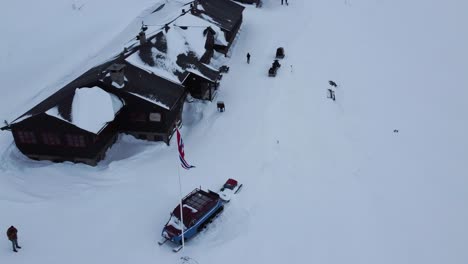 Static-Aerial-Over-Smuksjøseter.-Norwegian-Flag.-Snowy-Surroundings