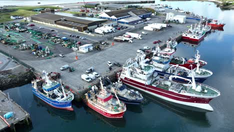 Drone-view-of-a-working-fishing-harbour-with-boats-docked-in-Castletownbere-harbour-West-Cork-Ireland-early-morning-in-summer