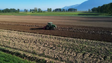 Paisaje-Rural-Escénico:-Tractor-Labrando-Tierra-Para-La-Siembra-De-Primavera-En-Una-Hermosa-Parcela-Agrícola-Con-Fondo-Colorido