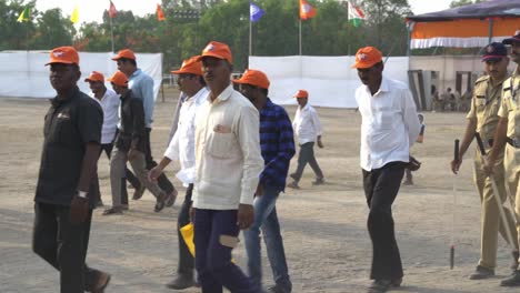 Crowd-of-people-wearing-BJP-merchandise-walking-towards-campaign-ground-during-Bhartiya-Janta-Party-Lok-Sabha-Election-campaign-by-Indian-Prime-Minister-Narendra-Modi