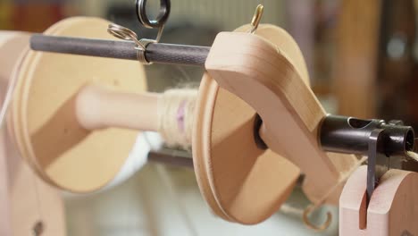 Close-up-detail:-Wool-yarn-spun-onto-modern-spinning-wheel-bobbin