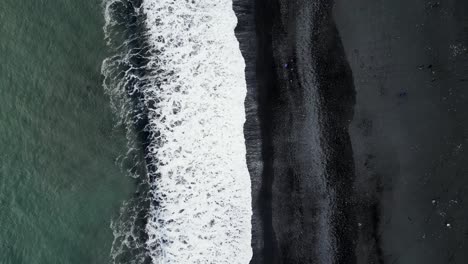 Aerial-shot-of-black-beach-in-iceland-during-winter-in-the-morning