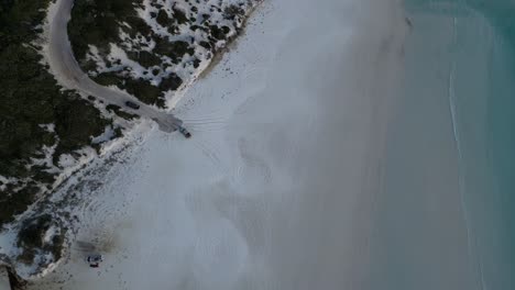 Vehicles-leaving-sandy-beach-of-Wharton-during-sunny-day-in-Australia