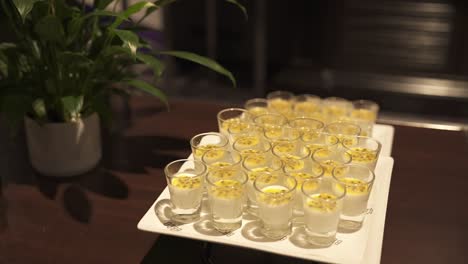 Tray-of-passionfruit-panna-cotta-desserts-elegantly-arranged-on-a-buffet-table