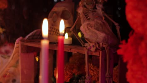 Candles-and-skeleton,-dark-spooky-decor,-tilt-shot