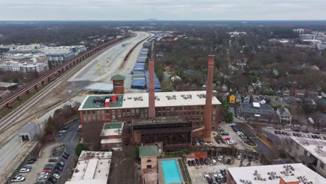 Aerial-of-Atlanta-Cabbagetown-community-housing-and-Intown-neighbourhood,-Fulton-Cotton-Mill-Lofts-and-massive-shipping-Yard-facility,-Georgia,-USA