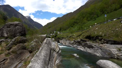 Green-water-flows-through-the-polished-stones-in-Lavertezzo,-Verzasca-Valley