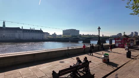 People-During-Sunny-Day-In-Albert-Embankment-With-Westminster-Bridge-In-The-Background-In-Westminster,-London-City,-England