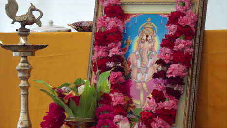 A-portrait-of-the-Hindu-deity,-Ganesh-adorned-with-a-flower-necklace