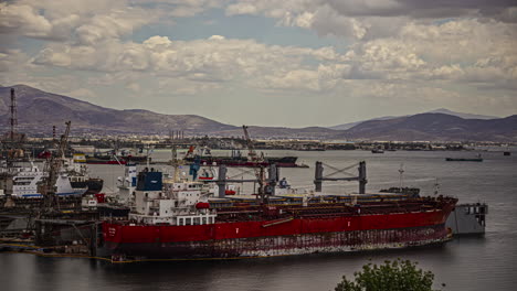 Ships-docked-at-Elfsina,-Greece-terminal---time-lapse-cloudscape