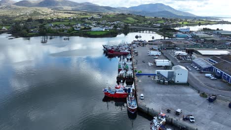 Drone-Castletownbere-fishing-harbour-flyover-working-docks-with-fishing-boats-unloading-west-Cork-Ireland-early-on-a-summer-morning