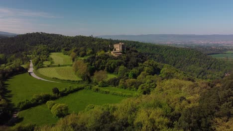 The-ancient-salvassola-vic-castle-surrounded-by-lush-forests-and-fields-near-barcelona,-aerial-view