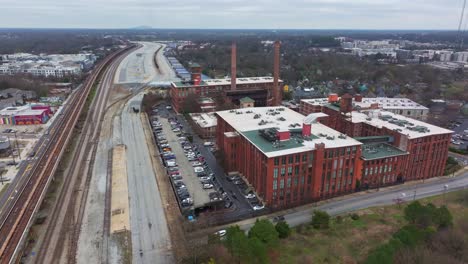 Aerial-of-the-vastness-of-Hulsey-Yard-stretching-east,-near-Cabbagetown-Fulton-Cotton-Mill-Lofts