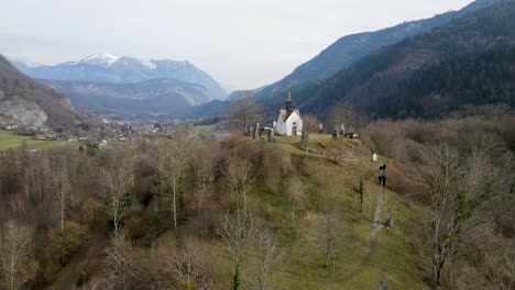 Miniature-church-in-a-scenic-mountain-valley-on-top-of-a-small-hill-in-France,-La-Tour