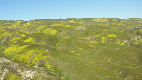 Aerial-drone-fly-Carrizo-Plains-foothills-of-Californian-geological-landscape,-skyline-background,-flying-slow-above-historical-landmark