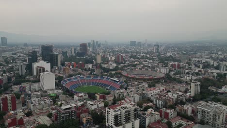 Aerial-View-as-approaching-Estadio-Azul-and-Plaza-de-Toros-Mexico,-Located-in-Ciudad-de-los-Deportes,-CDMX