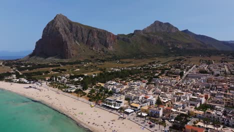 Drone-Flies-Away-from-San-Vito-Lo-Capo-to-Reveal-Picturesque-Beach-on-Typical-Summer-Day