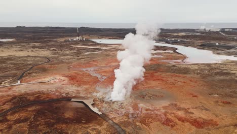 Vibrant-gunnuhver-hot-springs-in-iceland,-showcasing-steam-vents-and-colorful-geothermal-area,-aerial-view