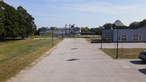 Drone-Shot-With-the-Drone-Flying-Slowly-Towards-the-Entrance-Road-of-an-Industrial-Zone-in-Tompa,-Hungary