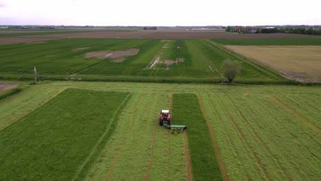 Farmer-sits-on-his-tractor-with-mower-bar-and-mows-the-grass-of-his-pasture