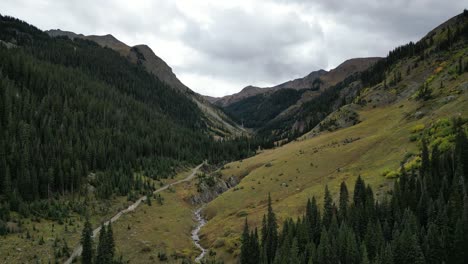 Aerial-View-of-Mountain-Valley-With-Winding-Trail