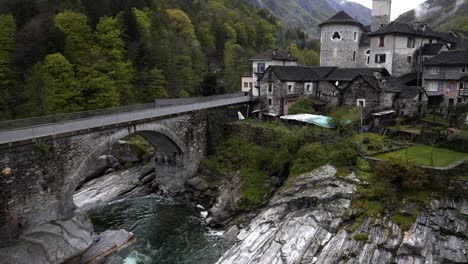 Pan-up-to-Church-in-Lavertezzo-Verzasca-Switzerland-at-base-of-alps-in-valley