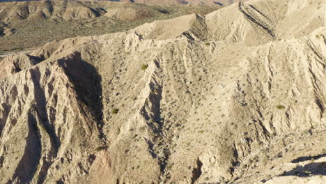 Remote-and-Barren-Badlands-Mountains,-Panning-shot,-Aerial