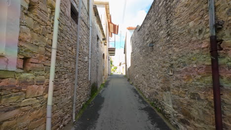 Una-Calle-Estrecha-E-Iluminada-Por-El-Sol,-Flanqueada-Por-Edificios-Tradicionales-De-Piedra-En-El-Histórico-Pueblo-De-Lefkara