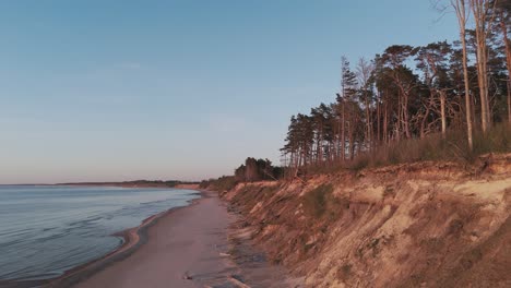 Establishing-Aerial-Shot-of-Coastline-Baltic-Sea-Jurkalne-on-Evening-at-Sunset