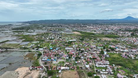 Aerial-panning,-cityscape,-blend-of-modern-buildings,-Indonesian-architecture