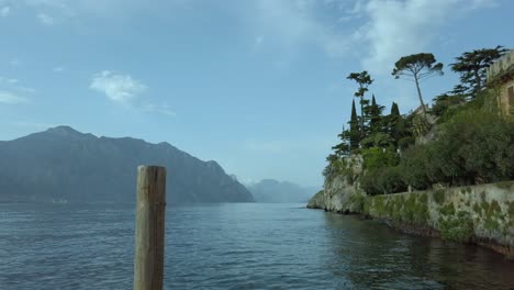 View-of-Lake-Garda-from-Malcesine,-showcasing-lush-greenery,-mountains,-and-historic-architecture