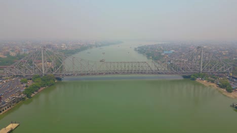 Aerial-view-of-Howrah-Bridge,-This-is-a-balanced-steel-bridge-over-the-Hooghly-River-in-West-Bengal,-India