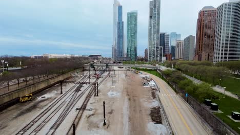 aerial-FPV-drone-footage-flying-through-a-train-yard-during-dusk-in-the-industrial-metropolis-city-of-Chicago