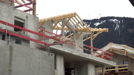 Concrete-apartments-under-construction-with-roof-rafters-and-beams-visible