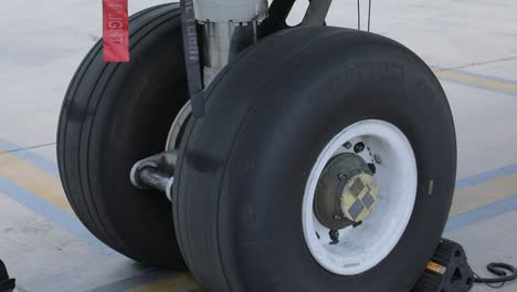 close-shot-captures-the-airplane's-front-wheels-on-the-ground,-showcasing-their-robust-construction-and-precision-in-ground-operations