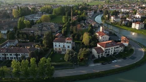 Ciudad-De-Mira-Y-Canal-De-Brenta-Al-Amanecer-Con-Sol-Brillante-En-Veneto,-Italia