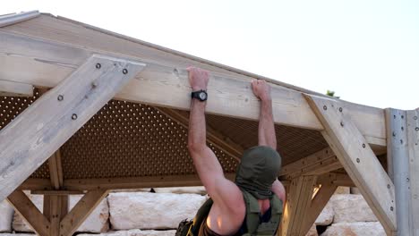 Hooded-man-doing-pull-ups