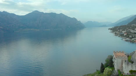 Luftaufnahme-Der-Burg-Von-Malcesine-Mit-Blick-Auf-Den-Gardasee,-Mit-Der-Stadt-Und-Dem-Wasser-Darunter,-Italien