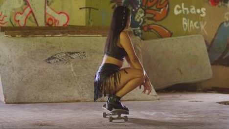 In-an-indoor-skatepark,-a-young-Hispanic-girl-in-a-mini-skirt-maneuvers-confidently-with-her-skateboard