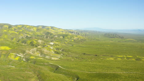 Panoramic-Aerial-Drone-Fly-Carrizo-Plain-Foothills-Green-landscape-blue-skyline-Californian-historic-landmark,-United-States-of-America
