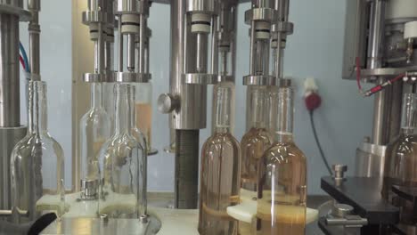 Rose-Wine-Bottles-In-Filling-Process-Production-In-A-Wine-Bottling-Factory